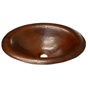 Oval copper bathroom sink with hammered texture and antique brown finish, shown from above.