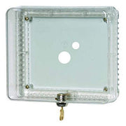 Clear plastic thermostat guard with two circular openings, brass hinges, and locking mechanism.