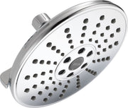 Round chrome shower head with multiple spray holes and center control dial for adjusting water settings.