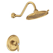 Brushed gold shower trim kit with single handle valve and oval rainfall showerhead with curved arm.