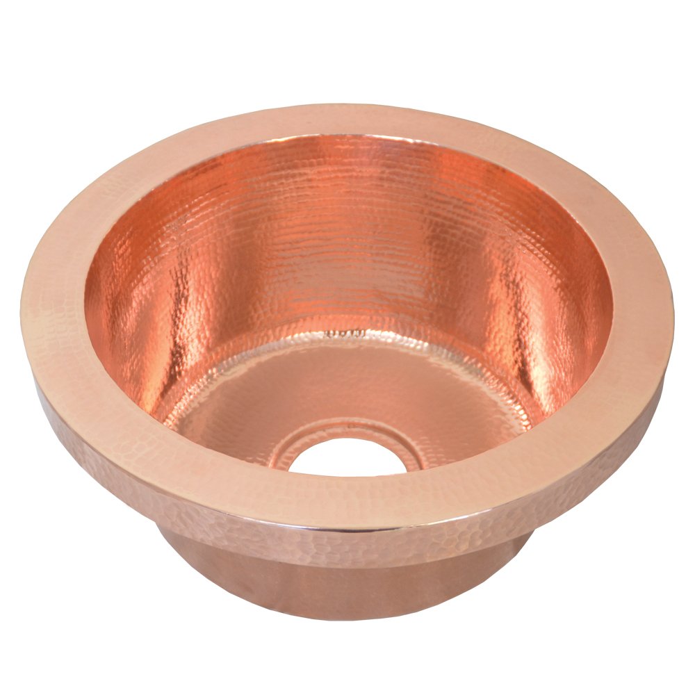 Polished copper round bar sink with hammered interior finish and single drain opening.