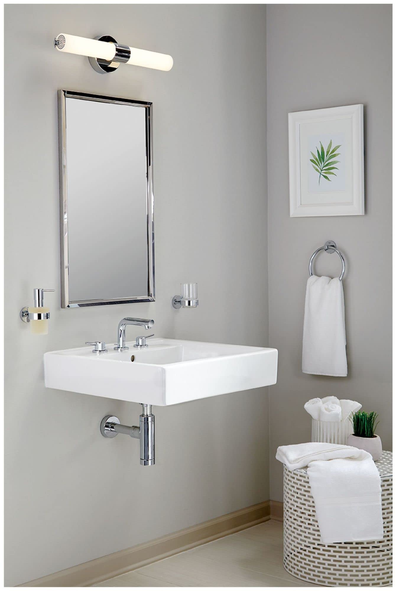 Chrome widespread bathroom faucet with two handles mounted on white rectangular sink.