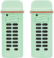 Two green toilet bowl cleaning refill cartridges with black cleaning tablets and red metal clips.