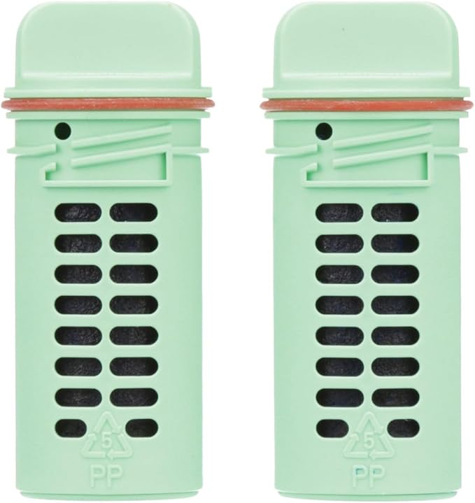 Two green toilet bowl cleaning refill cartridges with black cleaning tablets and red metal clips.
