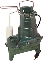 Green cast iron sewage pump with piggyback switch, discharge hose, and white float switch attached.