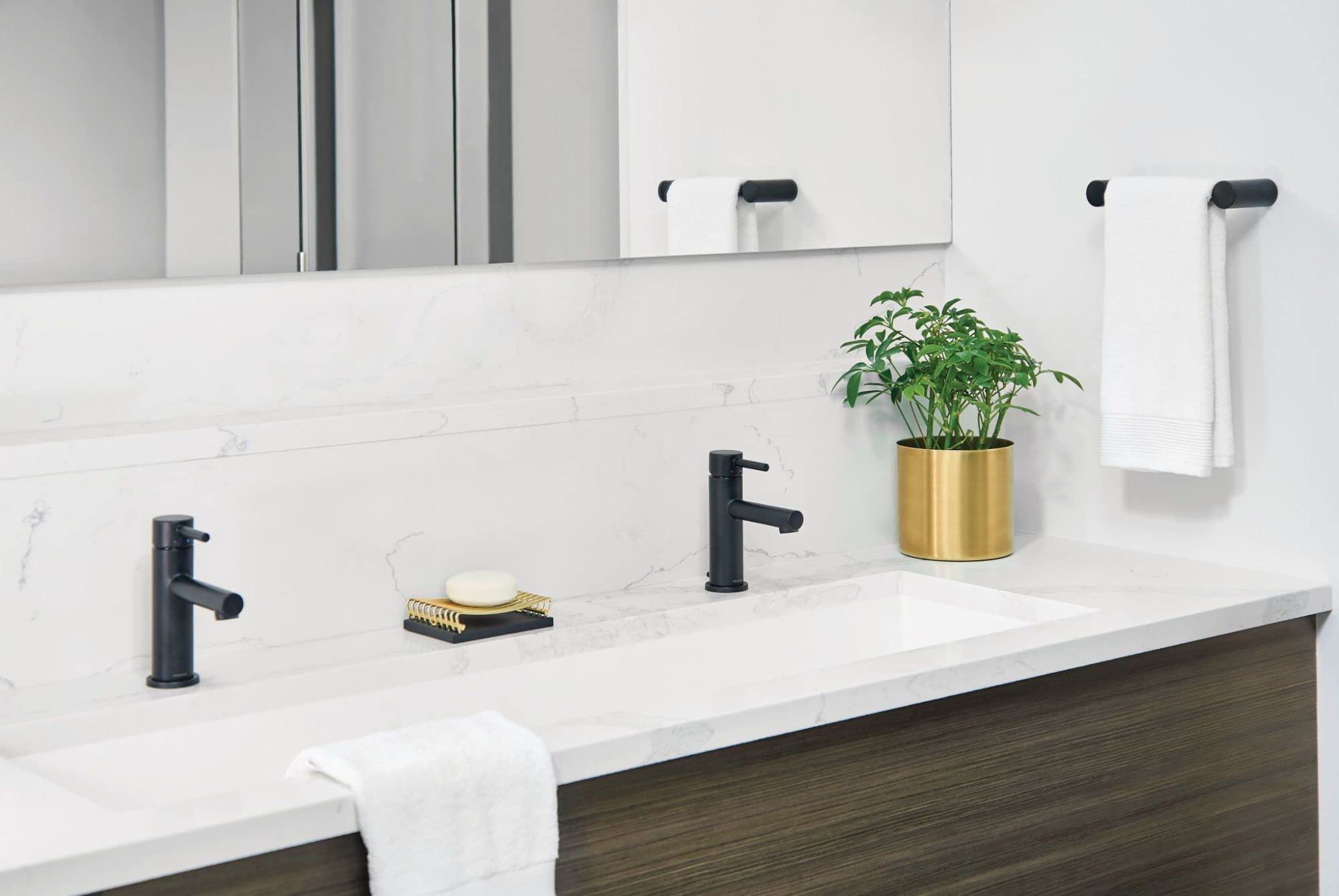 Matte black single-handle bathroom faucet with curved spout installed on white marble vanity countertop.