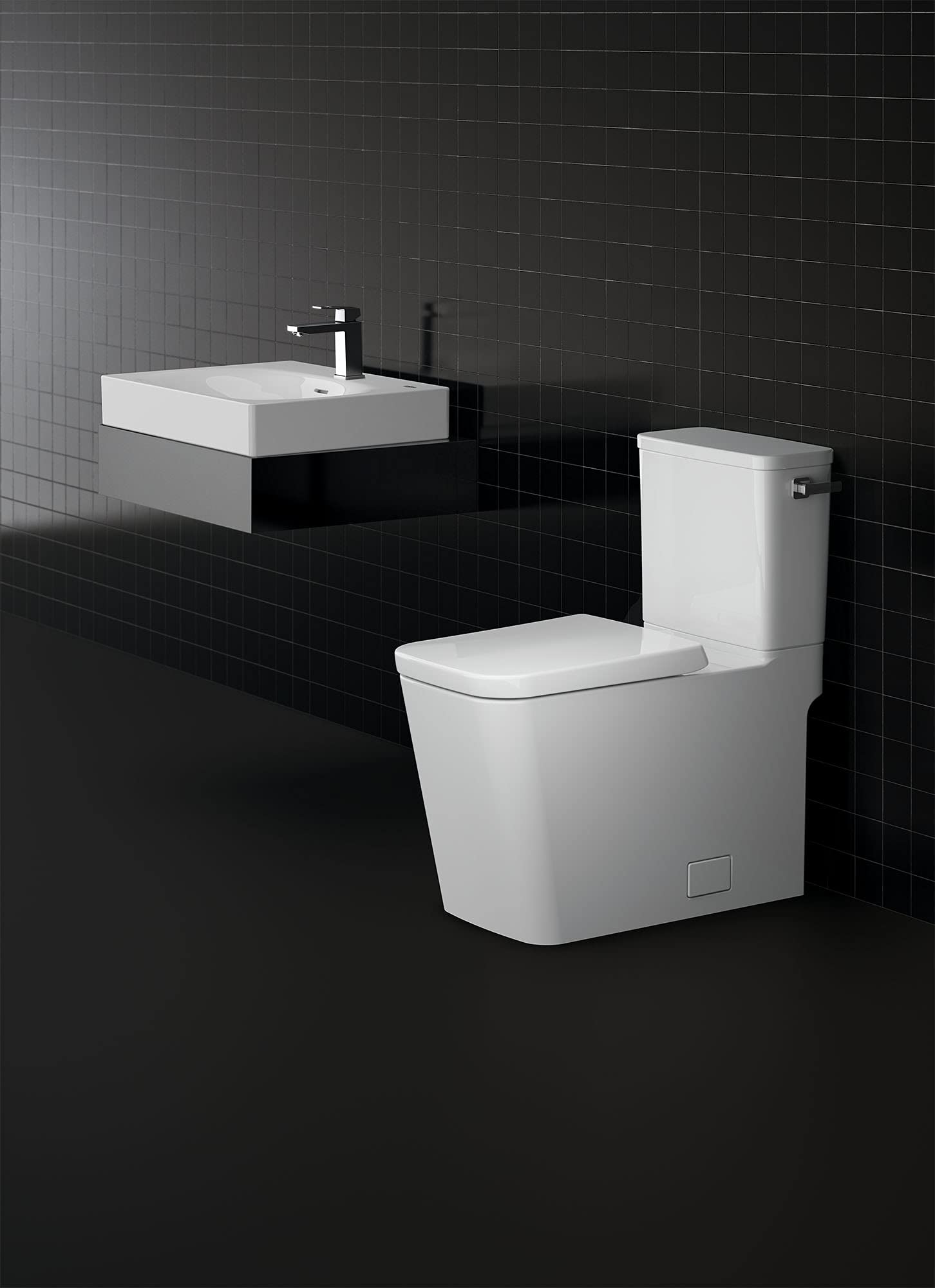 White two-piece elongated toilet with seat and matching tank on black tiled bathroom floor.