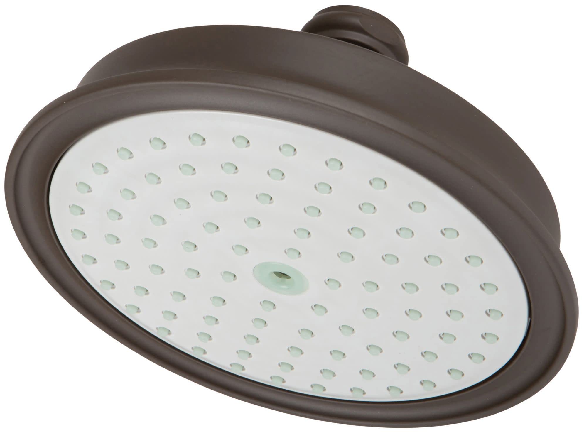 Oil rubbed bronze round shower head with white face plate and multiple spray jets.