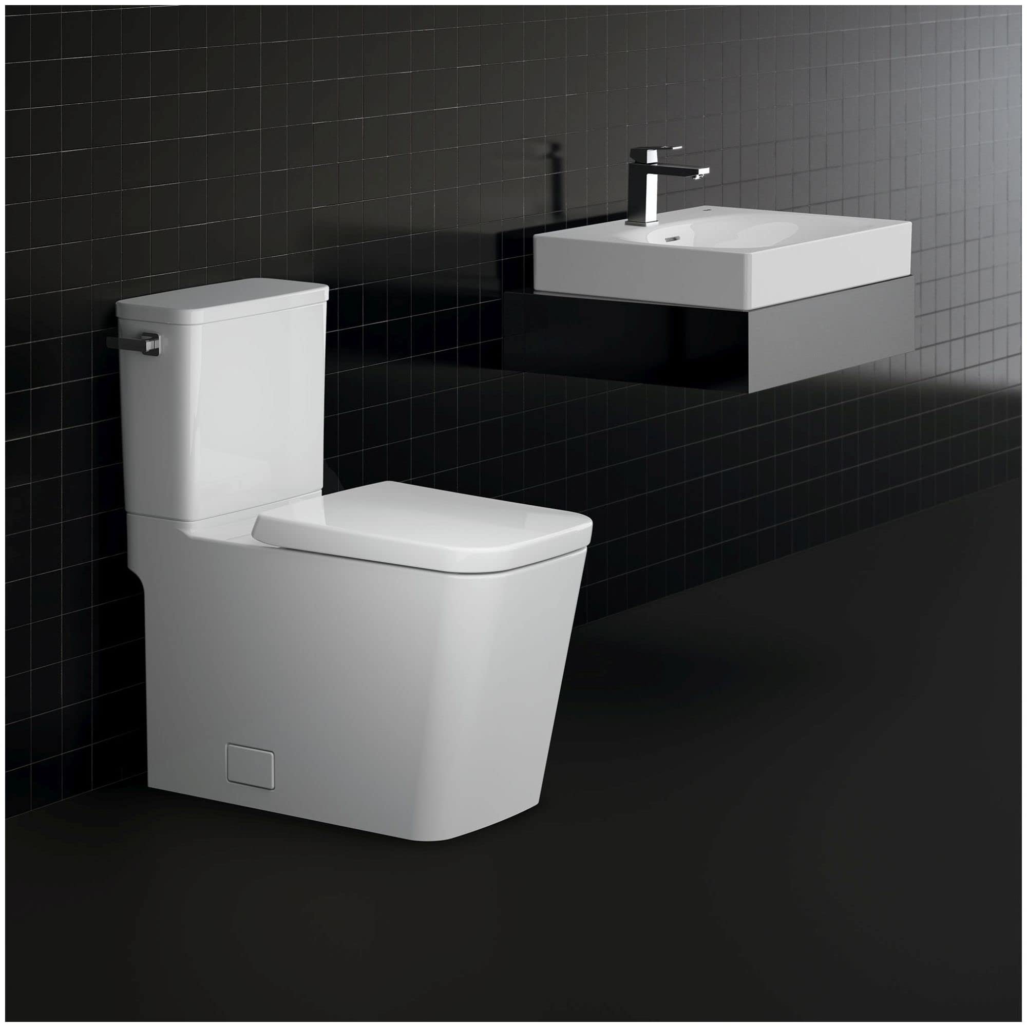 White two-piece elongated toilet with seat and left-hand trip lever in modern bathroom setting.