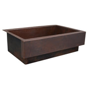 Antique copper kitchen sink with hammered texture and rectangular basin, apron front design.