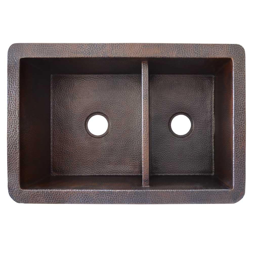 Antique copper kitchen sink with two equal bowls and hammered texture finish, shown from above.