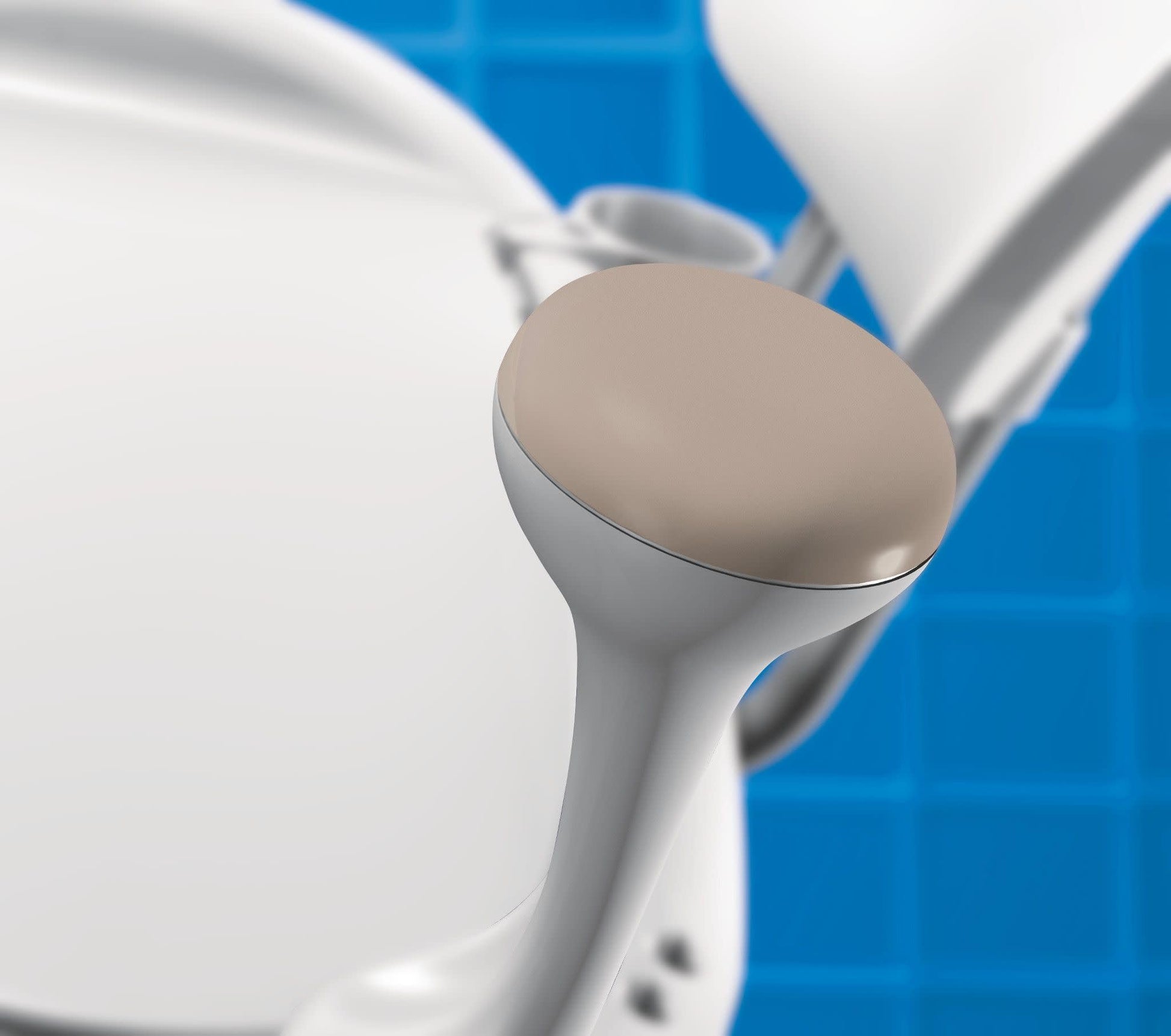 Close-up of beige padded seat and white frame of bath transfer bench with blue background.