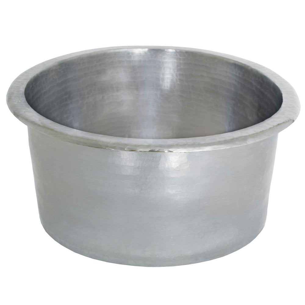 Hammered copper round bar sink with rolled rim and sloped interior basin.