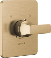Champagne bronze shower valve trim with single lever handle, H and C markings, and Delta branding on square escutcheon plate.