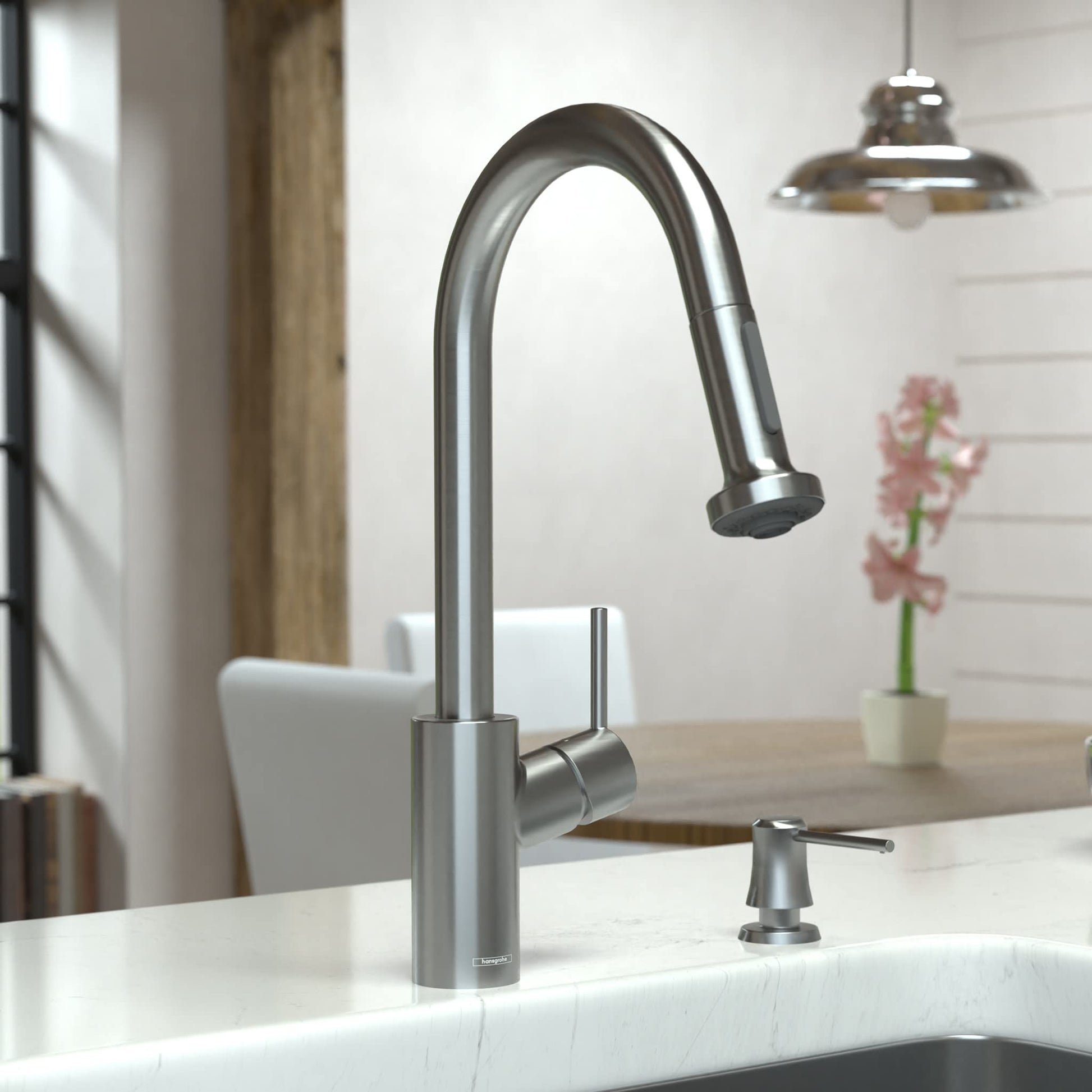 Steel Optic kitchen faucet with high arc spout, pull-down spray head, and separate soap dispenser on white sink.