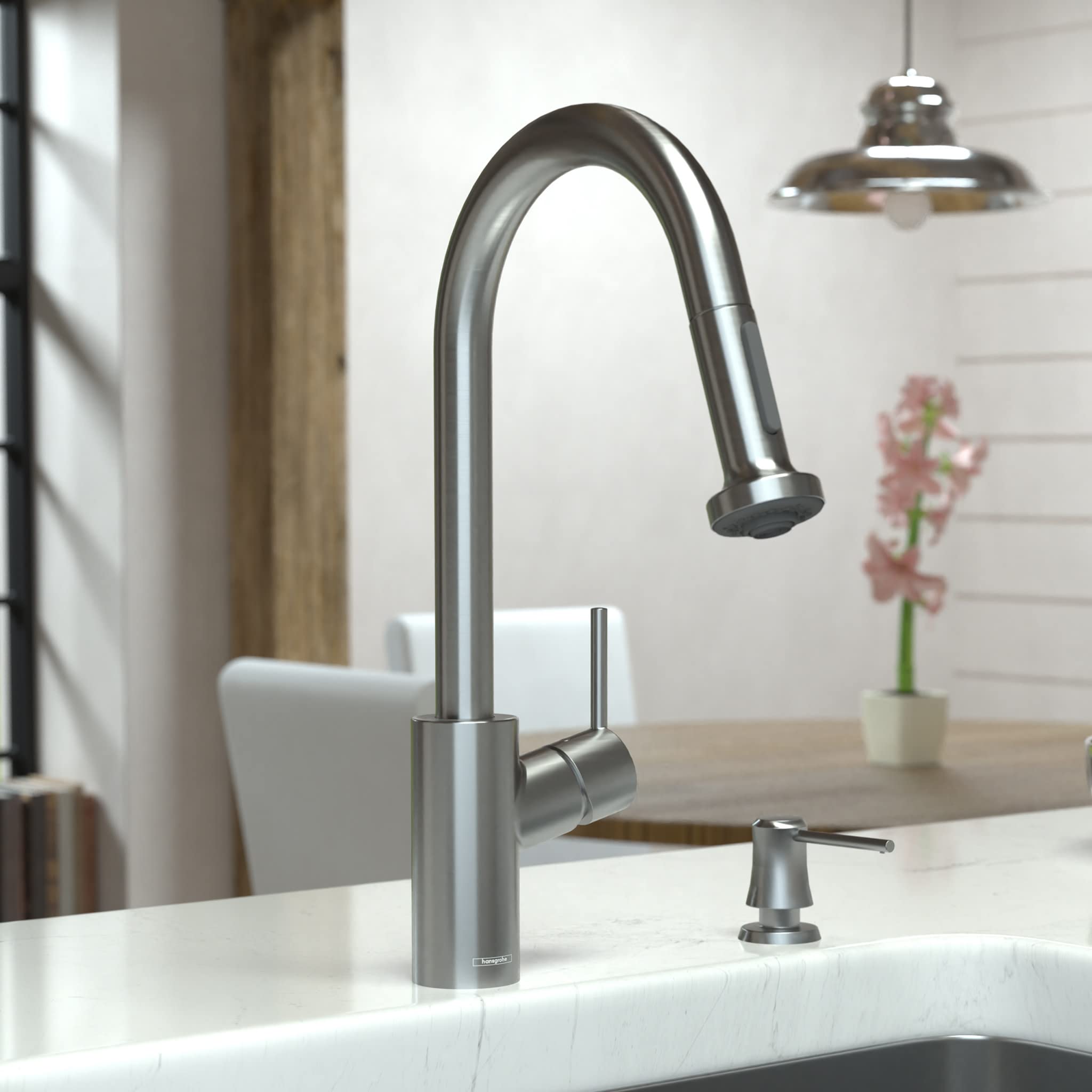 Steel Optic kitchen faucet with high arc spout, pull-down spray head, and separate soap dispenser on white sink.