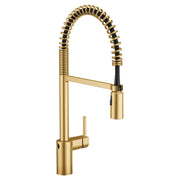 Brushed gold kitchen faucet with coiled spring sprayer and single handle lever.