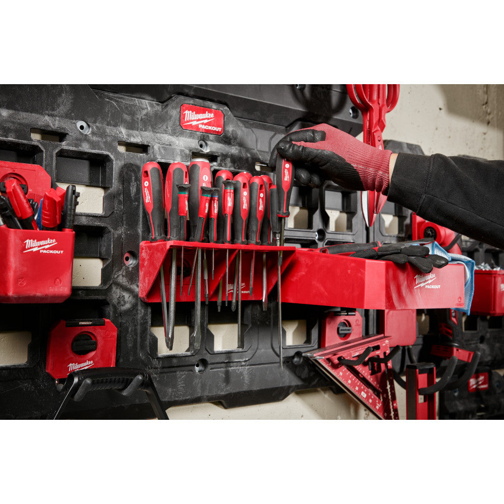 Red and black Milwaukee PACKOUT screwdriver rack holding multiple screwdrivers of varying sizes, mounted on modular storage s
