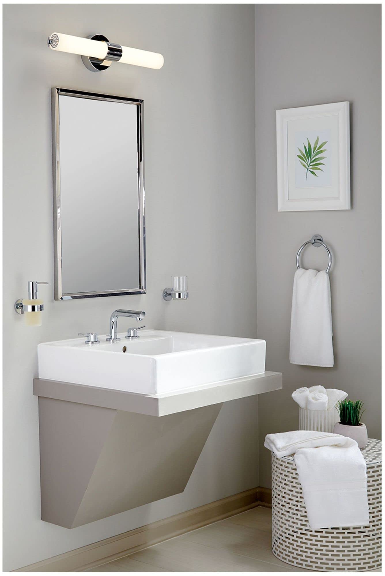 Matte black widespread bathroom faucet with two handles mounted on white rectangular sink basin.