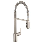 Stainless steel kitchen faucet with tall rectangular base, arched spout, and coiled pull-down spray hose.