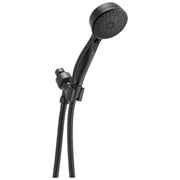 Black Delta shower head with perforated face mounted on adjustable arm with hose and wall bracket.
