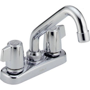 Chrome two-handle laundry faucet with curved spout and blade handles on white base.