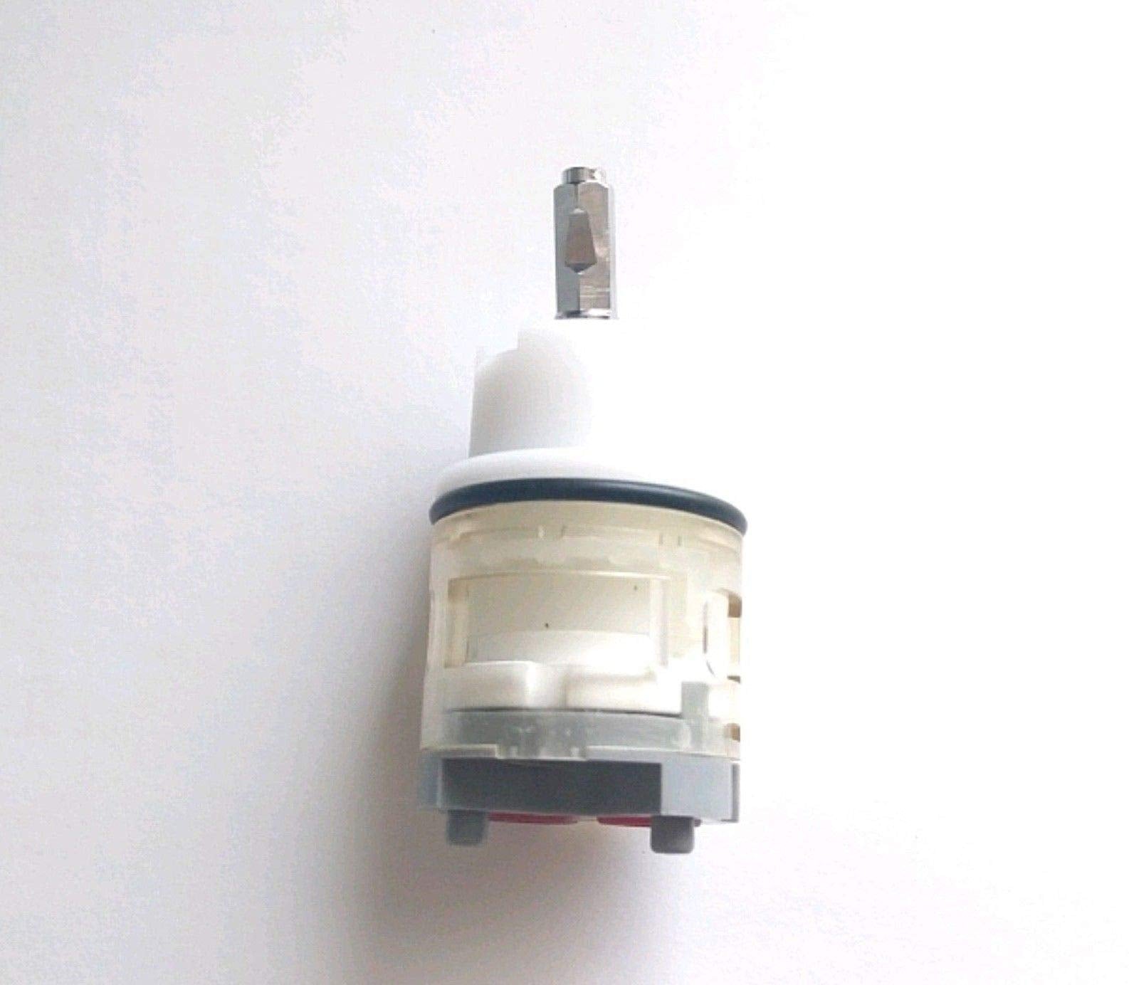 White and gray ceramic cartridge with metal stem for faucet valve replacement.