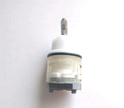 White and gray ceramic cartridge with metal stem for faucet valve replacement.