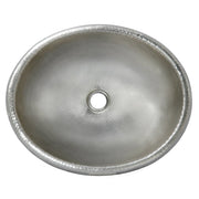Hammered copper oval bathroom sink with rolled rim and center drain hole, viewed from above.