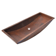 Antique copper trough sink with hammered texture and single drain hole, angled view.