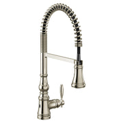 Polished nickel kitchen faucet with coiled spring spout and pull-down sprayer head.