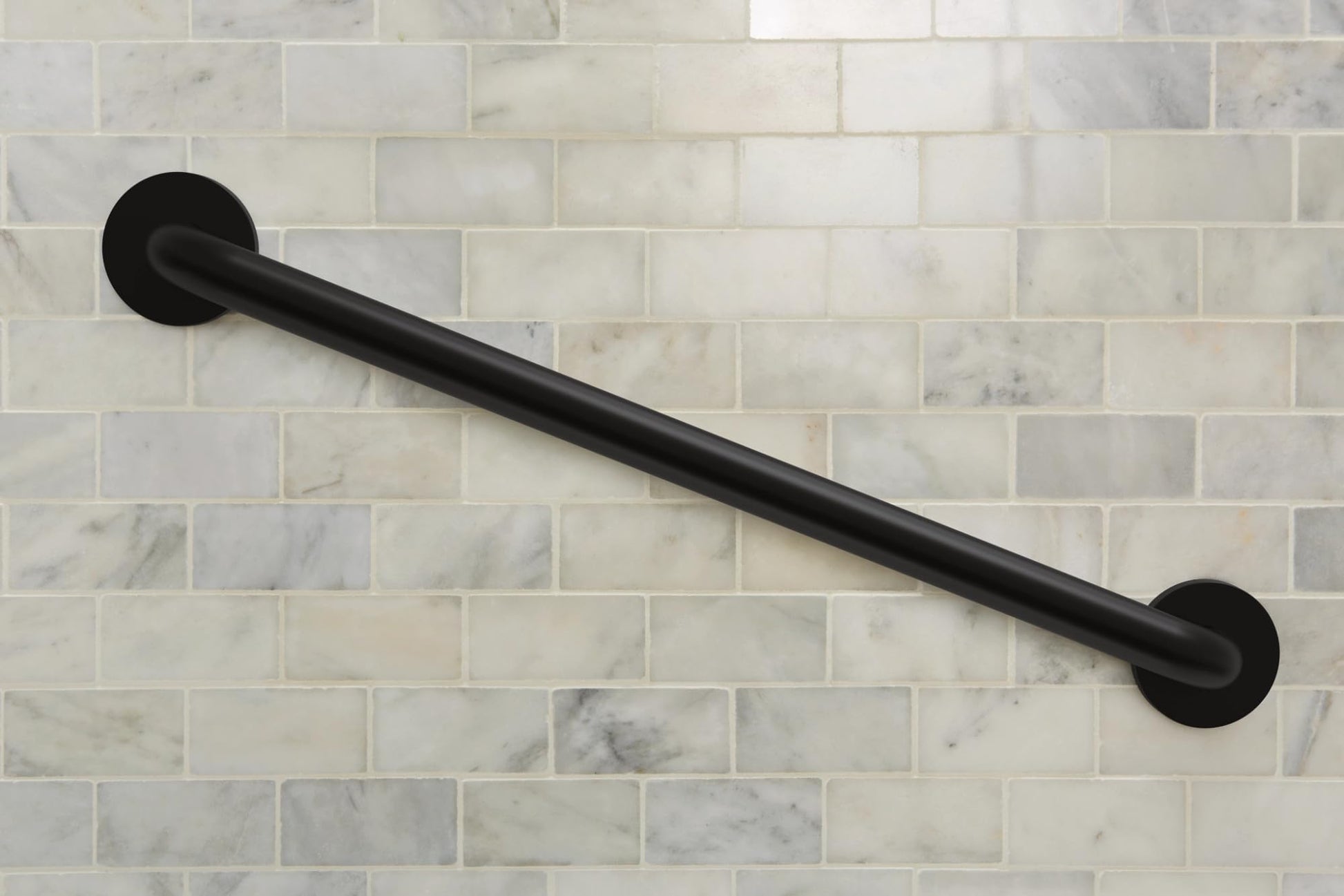 Black cylindrical grab bar with round mounting flanges mounted horizontally on subway tile wall.