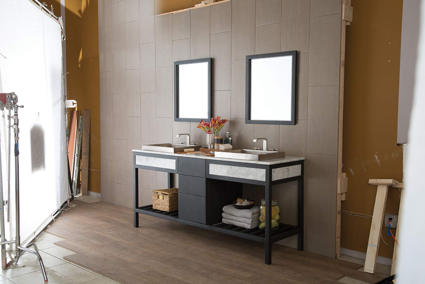 Black-framed rectangular mirror with white matting displayed above bathroom vanity.