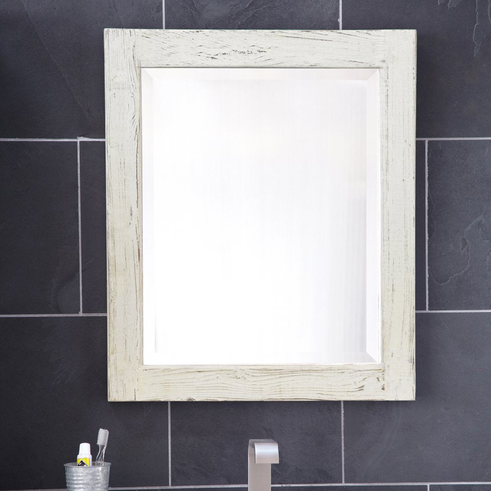 Whitewash wooden framed rectangular mirror mounted on black tile wall above bathroom vanity.