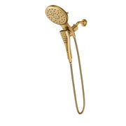 Brushed gold shower system with dual showerheads and handheld spray connected by flexible hose.