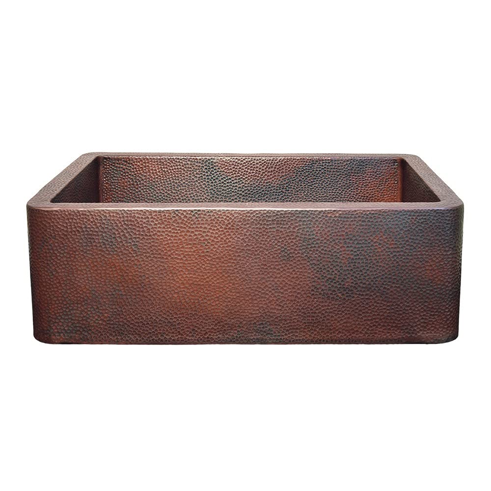 Antique copper farmhouse sink with hammered texture and single rectangular basin.