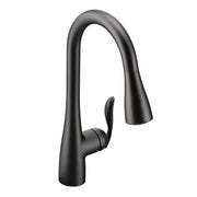 Matte black kitchen faucet with tall curved spout, single lever handle, and pull-down sprayer head.