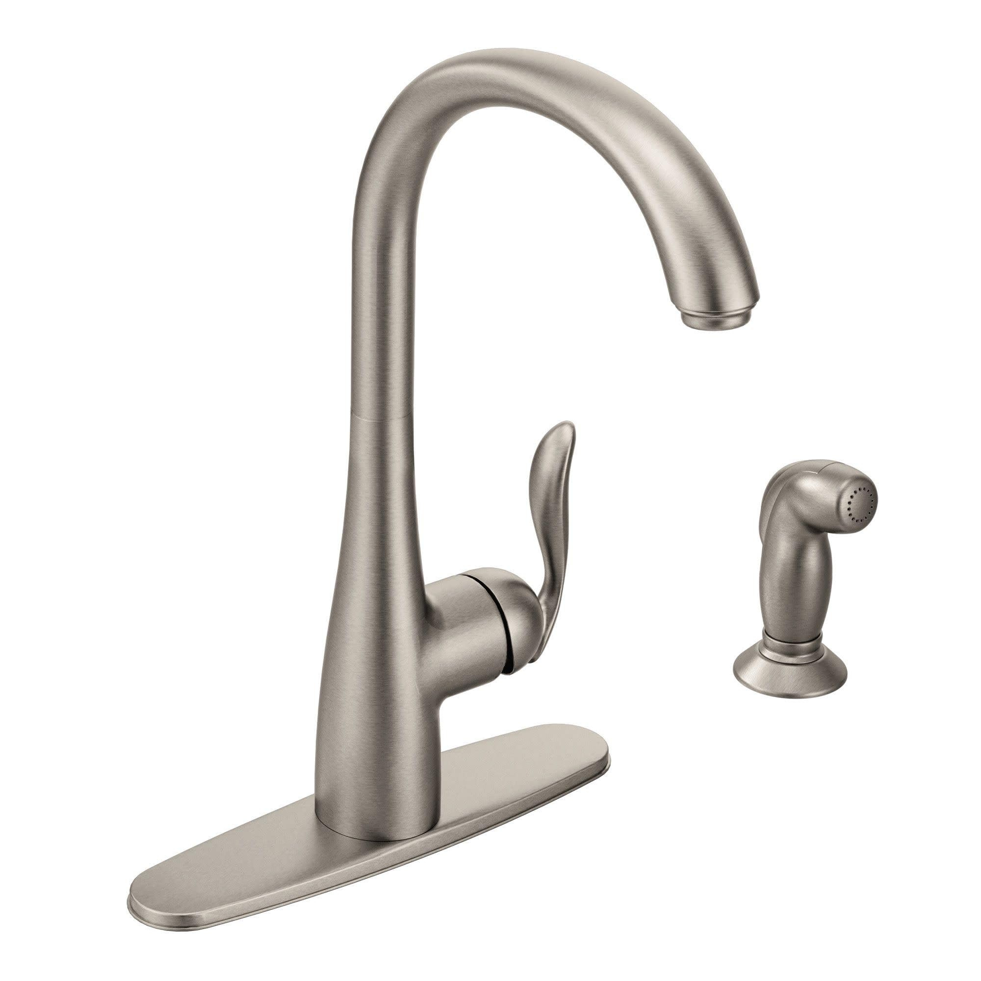 Stainless steel kitchen faucet with high arching spout, single lever handle, and separate side spray attachment on base plate