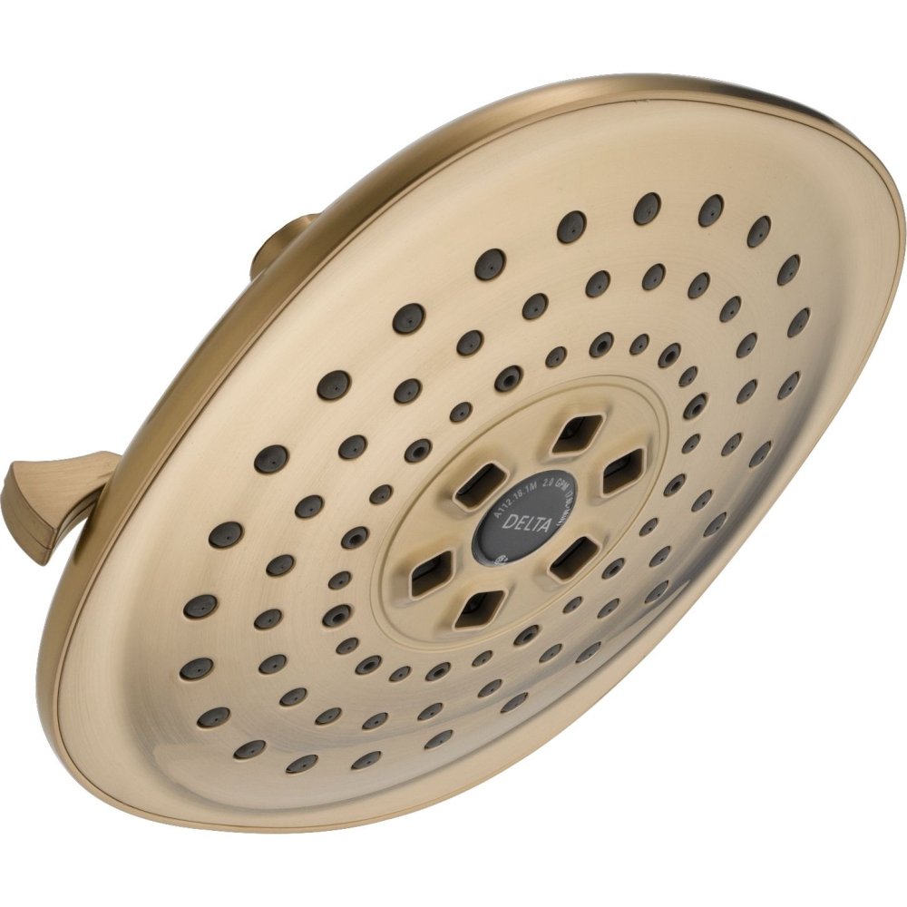 Champagne-bronze circular raincan shower head with multiple spray holes and central dial control knob.