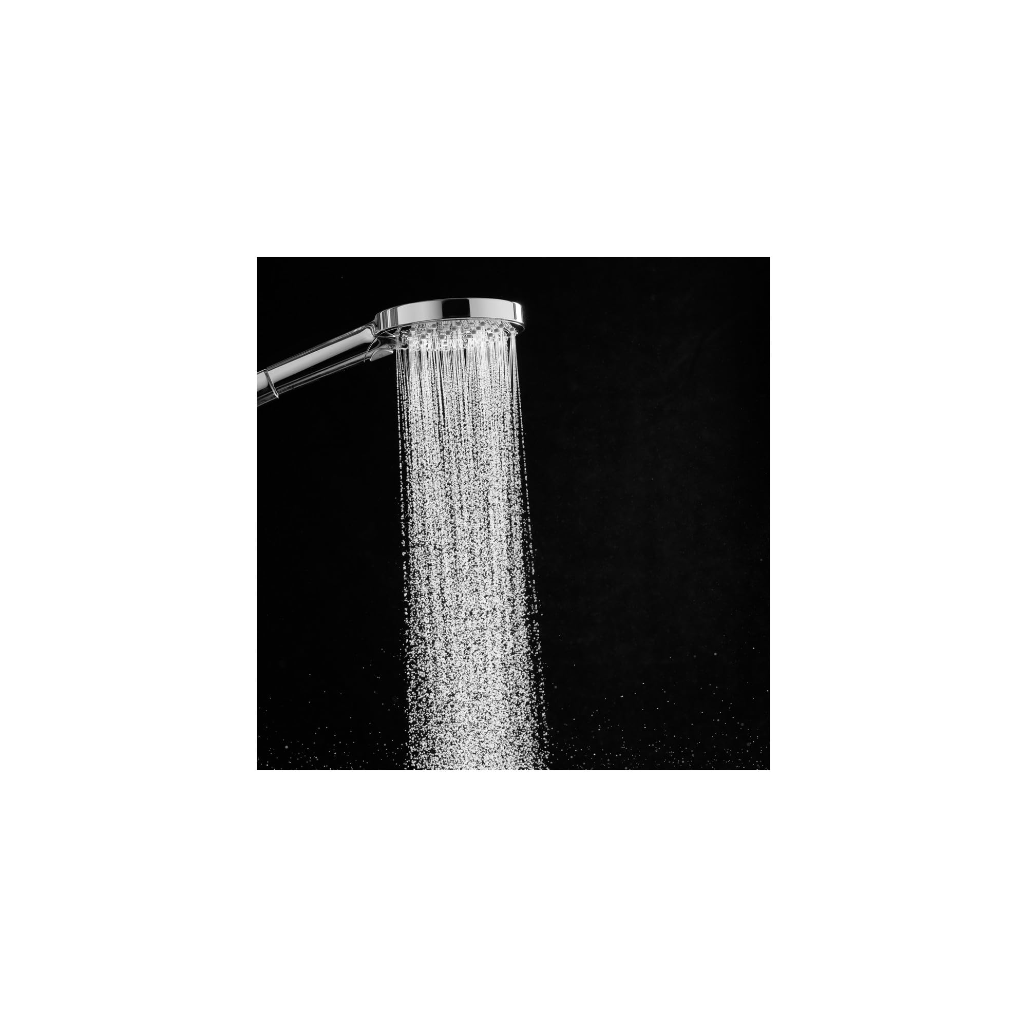 Chrome handheld shower head with round face spraying water stream against black background.