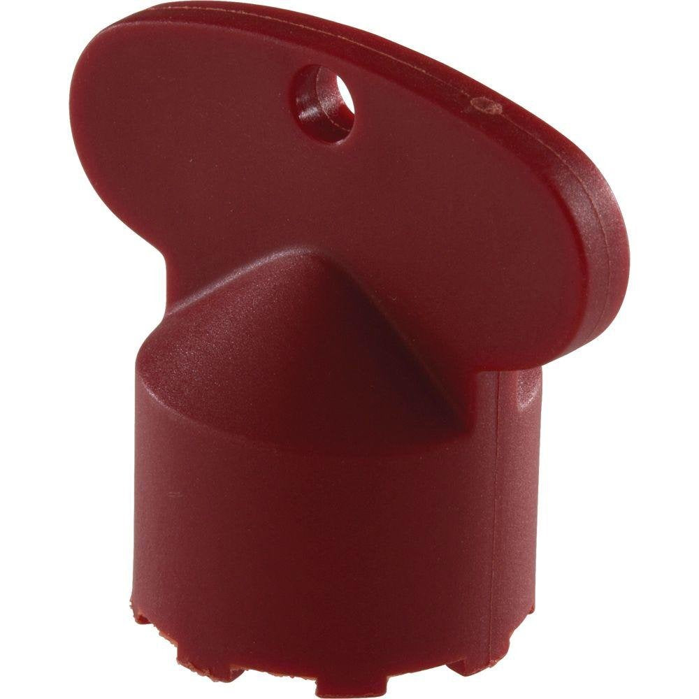 Red plastic aerator wrench tool with cylindrical body and angled head with mounting hole.