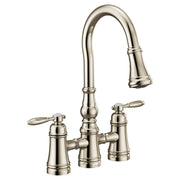 Polished nickel two-handle bridge kitchen faucet with high curved pulldown spout and lever handles.