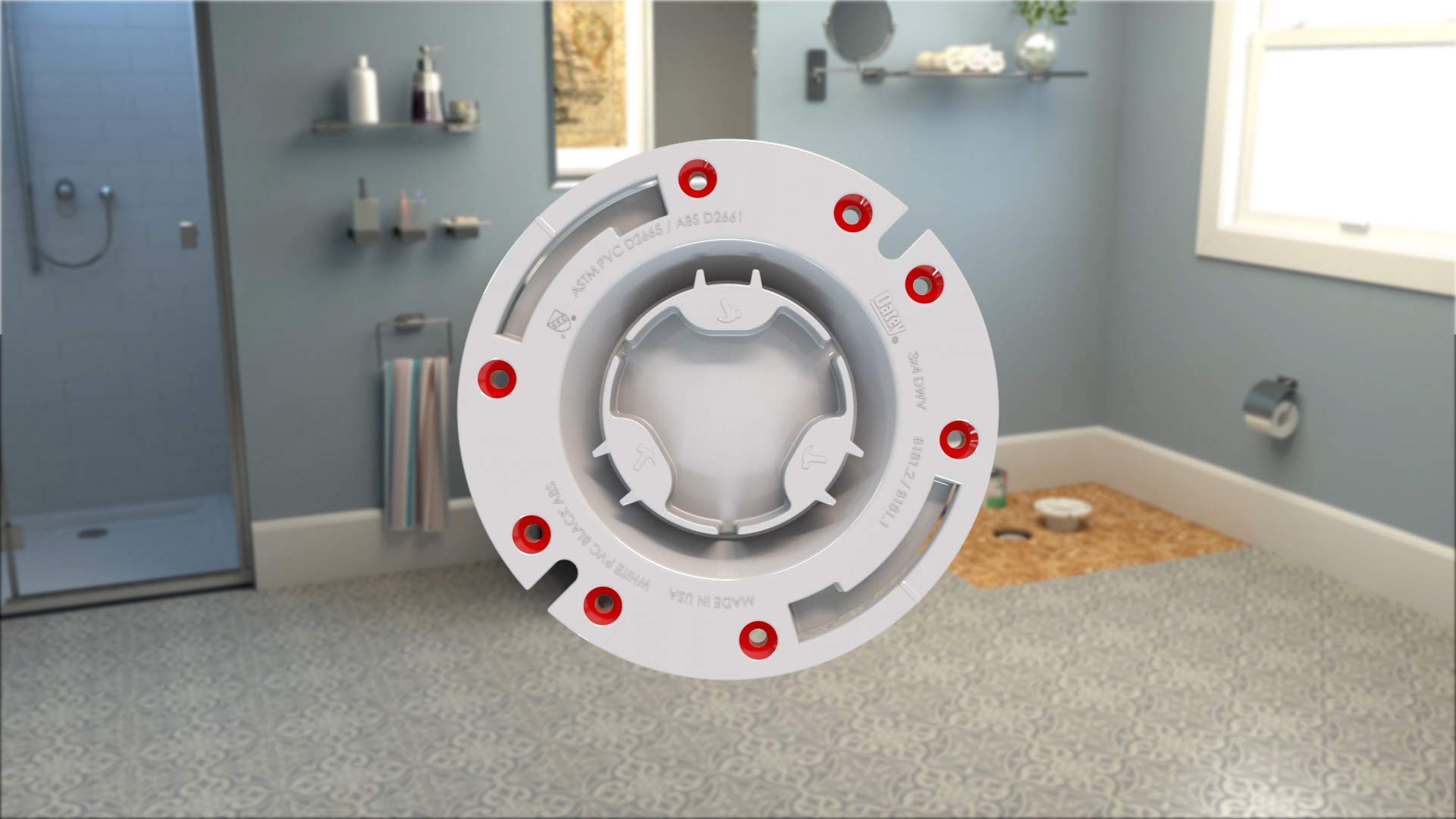 White PVC closet flange with red fastener holes and plastic ring, viewed from above on bathroom floor.
