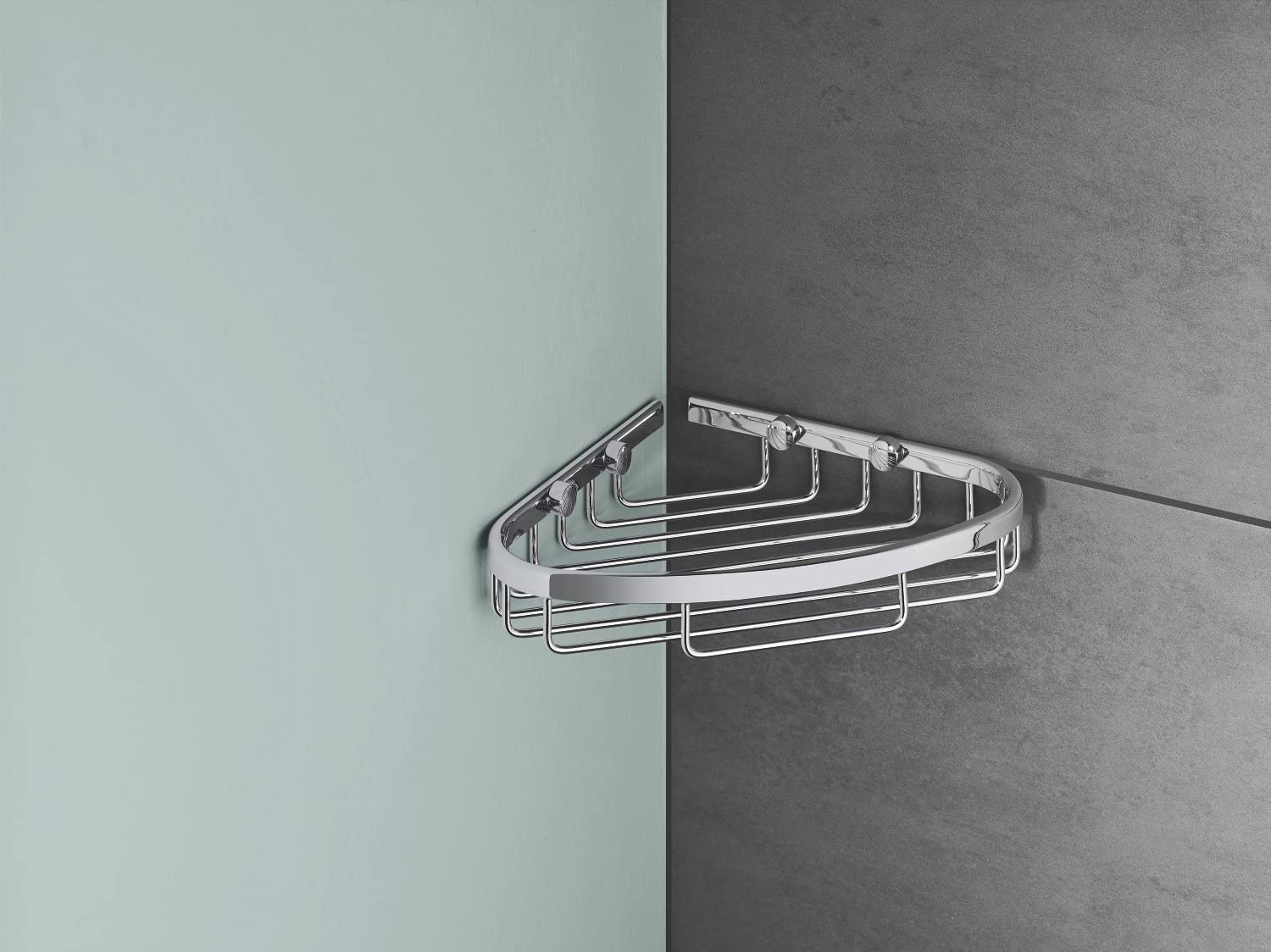Chrome corner wire basket with curved triangular design and multiple horizontal shelves mounted on tile wall.