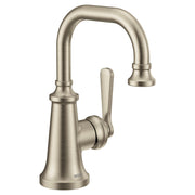 Brushed nickel single-handle bathroom sink faucet with curved spout and traditional design.