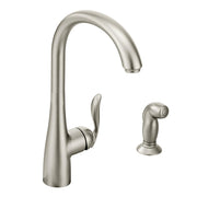 Stainless steel kitchen faucet with high arc spout, single handle, and detached side spray.
