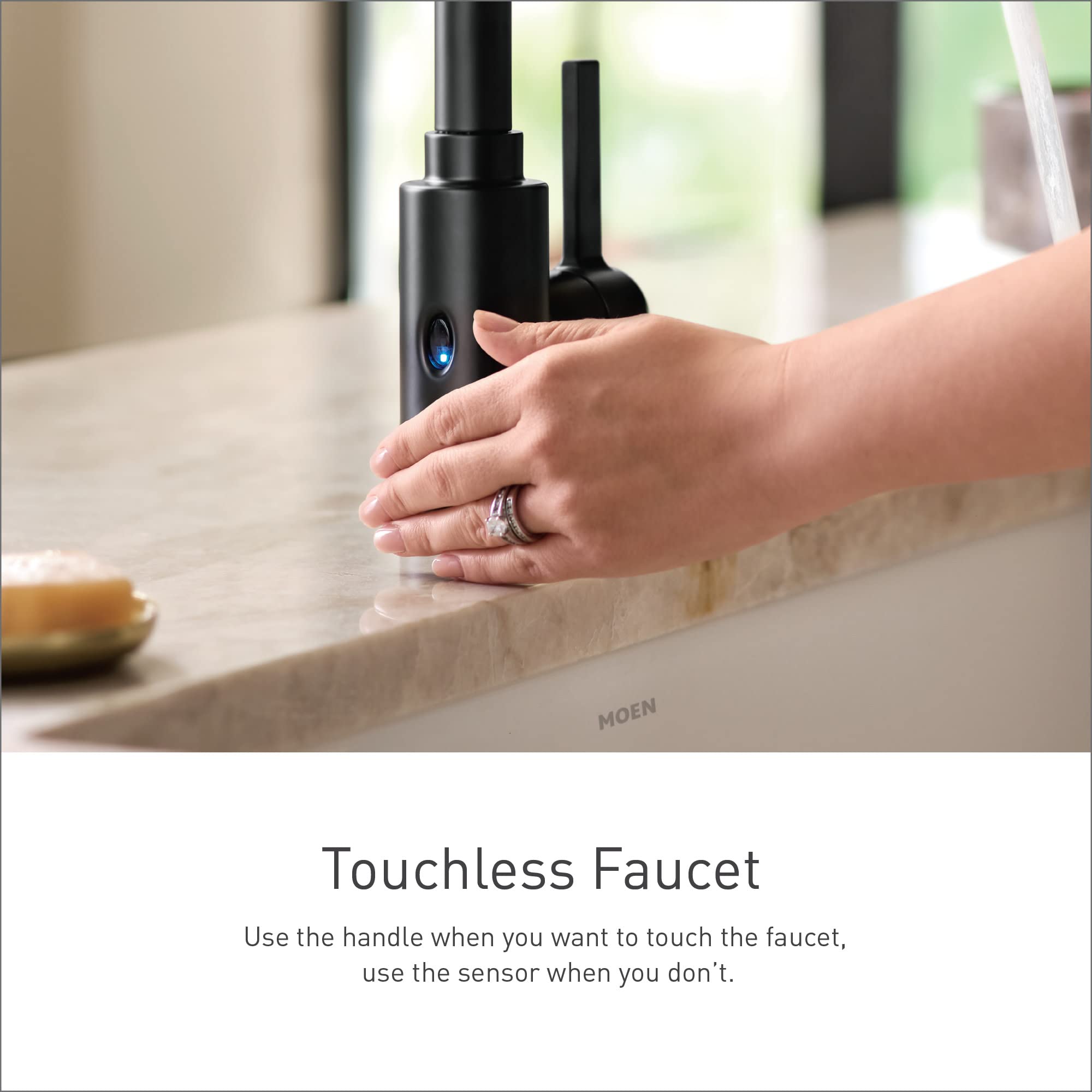Black stainless steel high arc kitchen faucet with motion sensor and single handle displayed with hand near sensor base.