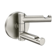 Brushed nickel double robe hook with two swiveling arms mounted on circular wall plate.
