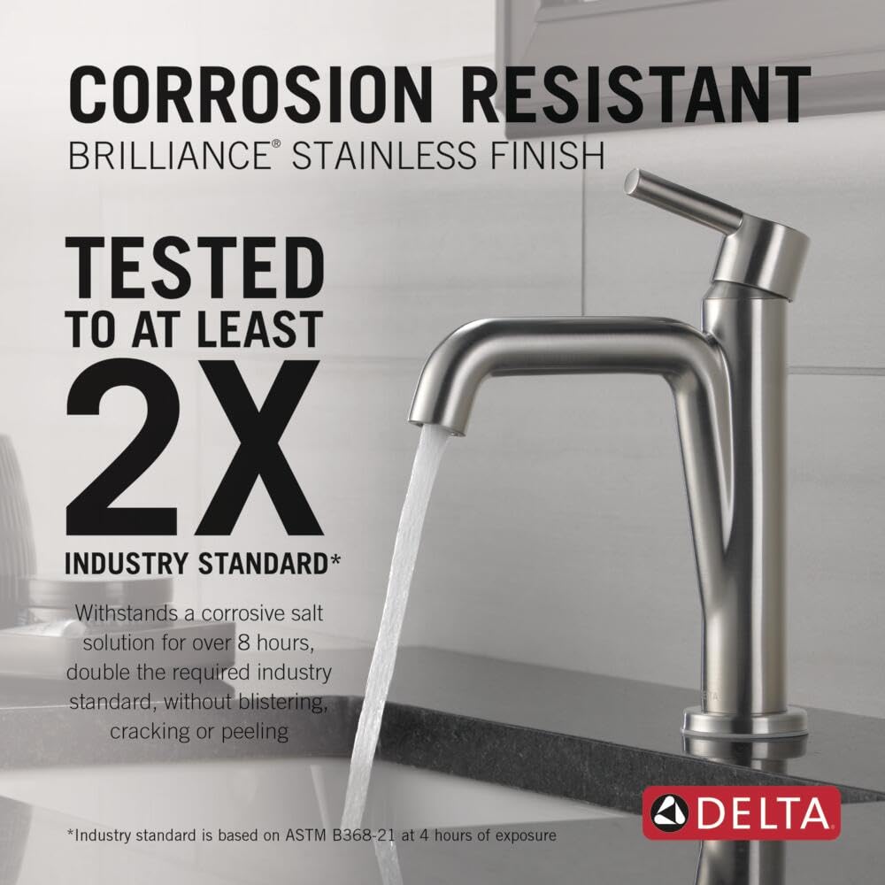 Stainless steel single-handle bathroom faucet with curved spout dispensing water into a sink.