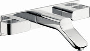 Chrome wall-mounted faucet trim with curved spout and three white rectangular basin-mounted handles.